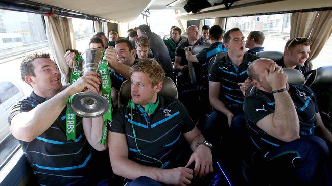 Peter O'Mahony and Chris Henry pass the Trophy around the bus 16/3/2014